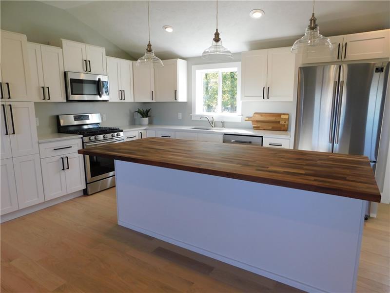 116 Grimm Road Sarver, PA 16055 - Photo 6 of 22 Kitchen with butcher block island and white shaker cabinets
