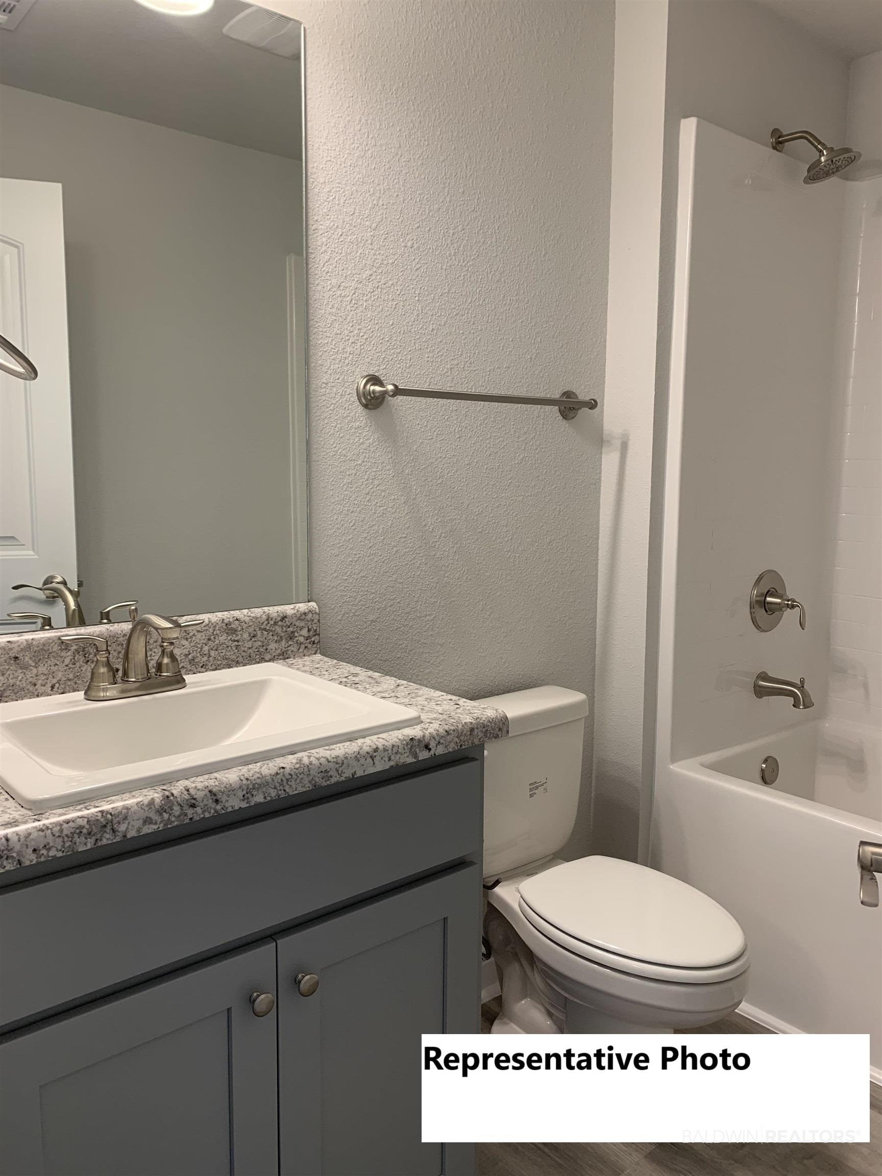 645 Revere Street Foley, AL 36535 - Photo 8 of 14 Full bathroom featuring shower combination, vanity, and toilet