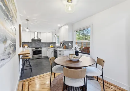 a view of a dining room with furniture window and wooden floor