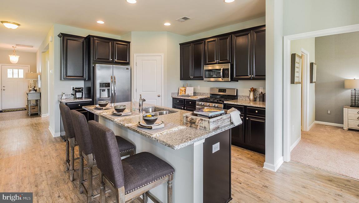 41 Walton Way Delanco, NJ 08075 - Photo 8 of 14 a kitchen with granite countertop a sink stove and refrigerator