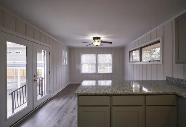 a kitchen with granite countertop a stove a sink and a window