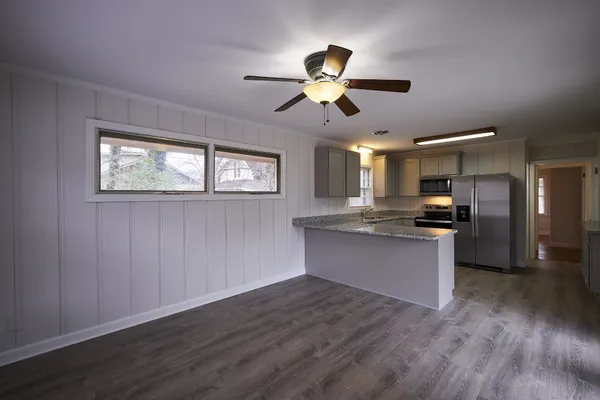 a view of kitchen with sink microwave and refrigerator