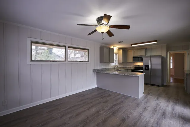 a view of kitchen with sink microwave and refrigerator