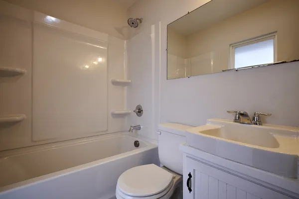 a bathroom with a sink a toilet and bathtub