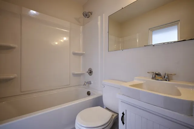 a bathroom with a sink a toilet and bathtub
