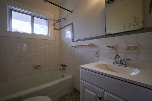 a bathroom with a sink a toilet and bathtub