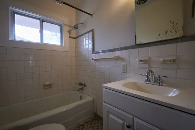 a bathroom with a sink a toilet and bathtub