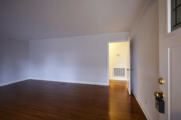 a view of a room with wooden floor