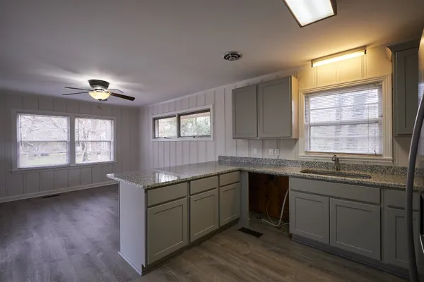 a kitchen with a sink stove and cabinets