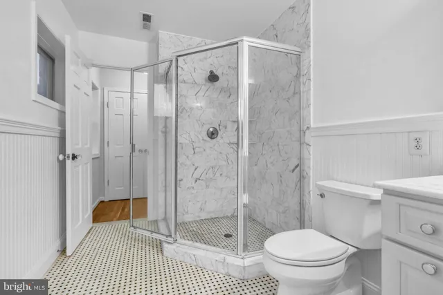 a bathroom with a shower and a toilet