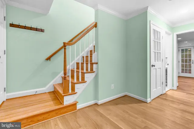 a view of entryway and hall with wooden floor