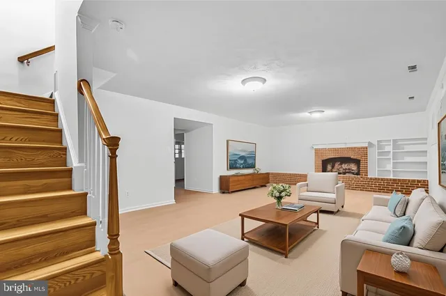 a living room with furniture and stairs