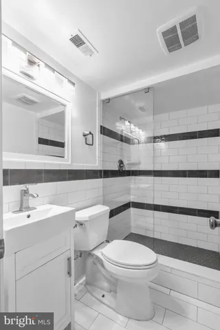 a bathroom with a toilet a sink and a mirror