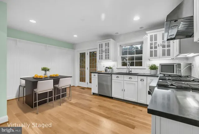 a kitchen with stainless steel appliances granite countertop a stove and a refrigerator