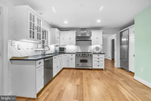 a kitchen with stainless steel appliances a sink and a refrigerator
