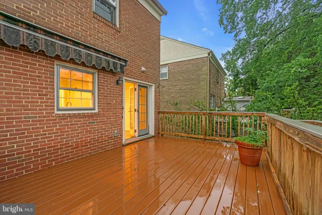 a view of a balcony with wooden floor and iron fence