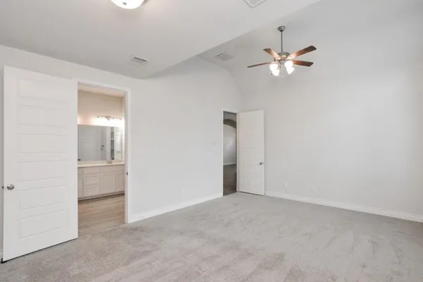 a view of an empty room with closet and a chandelier fan