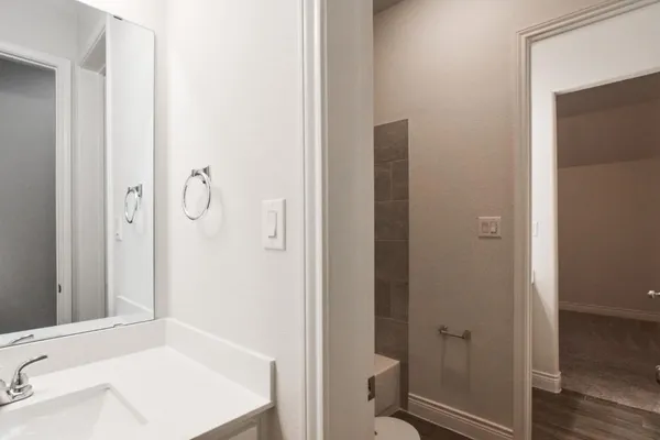 a bathroom with a tub sink vanity and a mirror