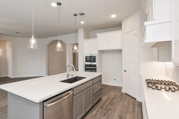 a kitchen with a sink a stove and refrigerator