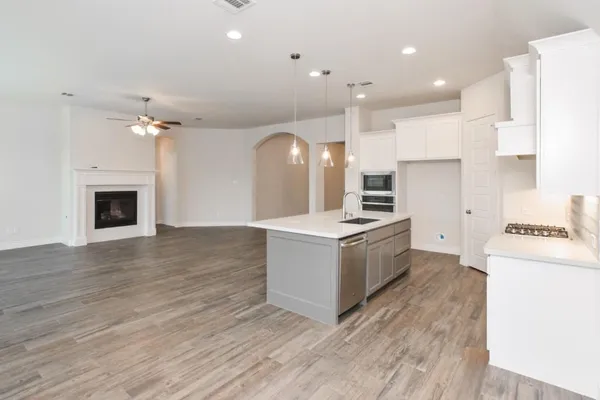 a kitchen with a stove a sink and a refrigerator