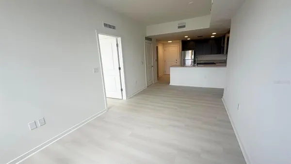 an empty room with kitchen and a sink