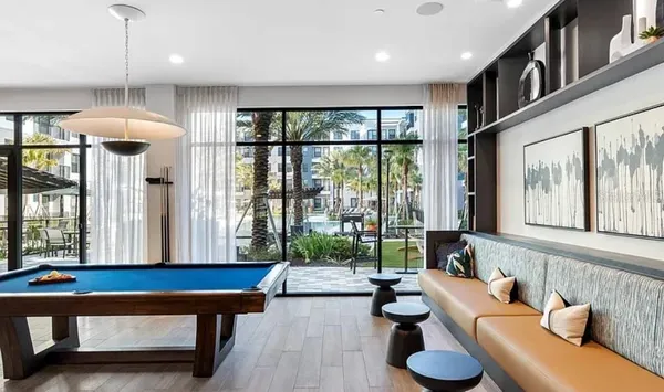a living room with furniture and a chandelier