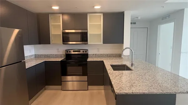 a kitchen with a stove and a refrigerator