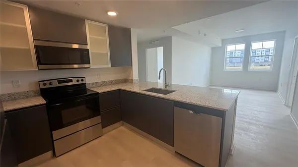 a kitchen with a sink and a stove top oven with wooden floor
