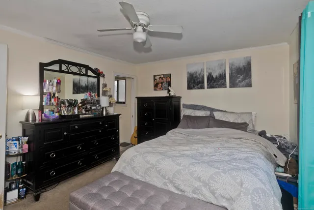 a bed room with a bed and a mirror