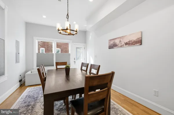 a view of a dining room with furniture window and wooden floor