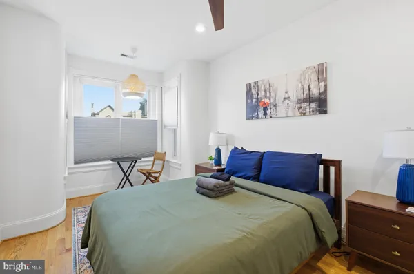 a bedroom with a bed and a chair