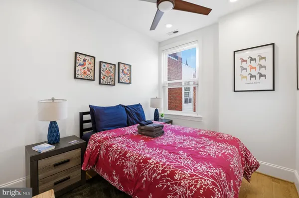 a bed sitting in a bedroom next to a window