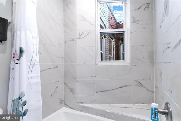 a bathroom with a bathtub and a shower