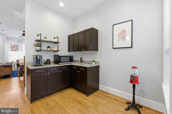 a kitchen with a sink cabinets and wooden floor