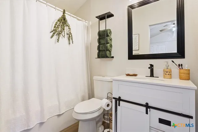 a view of a house with a yard and a large tree