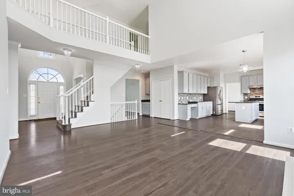 a view of large kitchen with wooden floor and windows