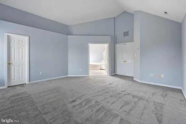 a view of an empty room with a cabinet