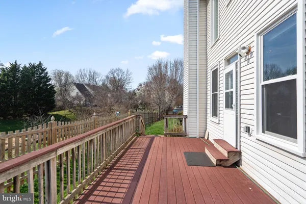 a view of balcony with wooden floor and fence