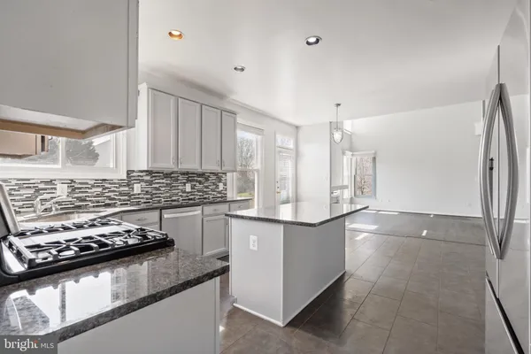 a kitchen with stainless steel appliances granite countertop a stove and a sink
