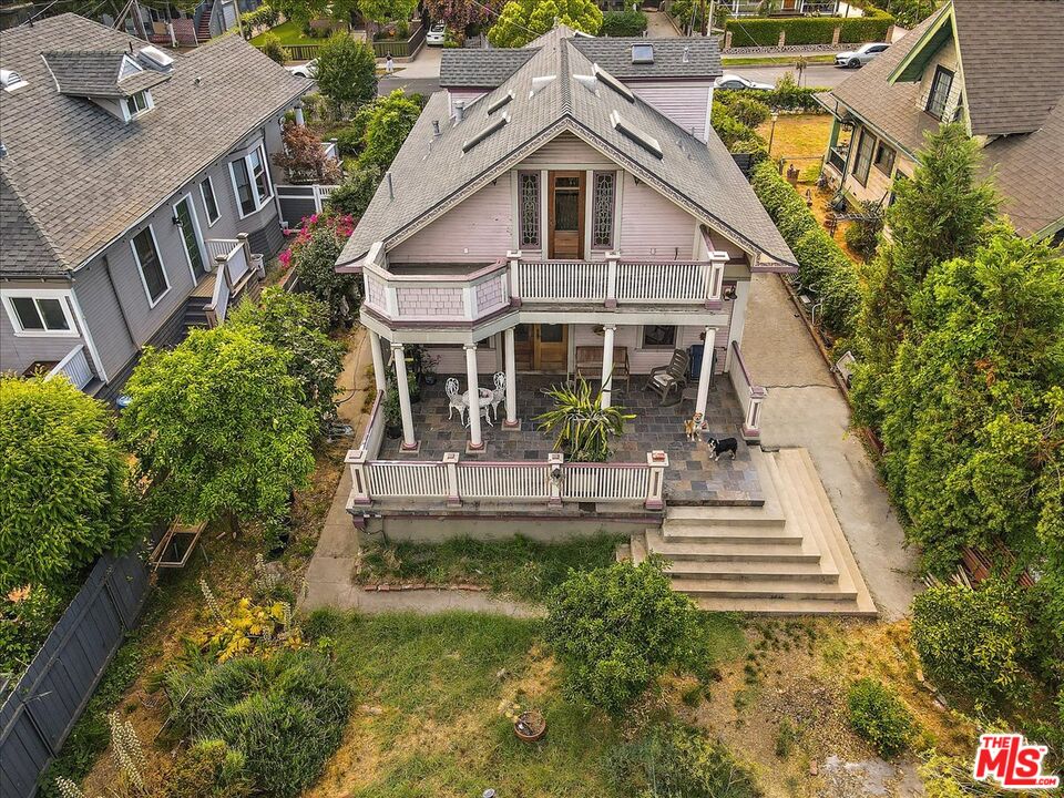 448 North Summit Avenue Pasadena, CA 91103 - Photo 16 of 16 a view of a white house with large windows and a small yard