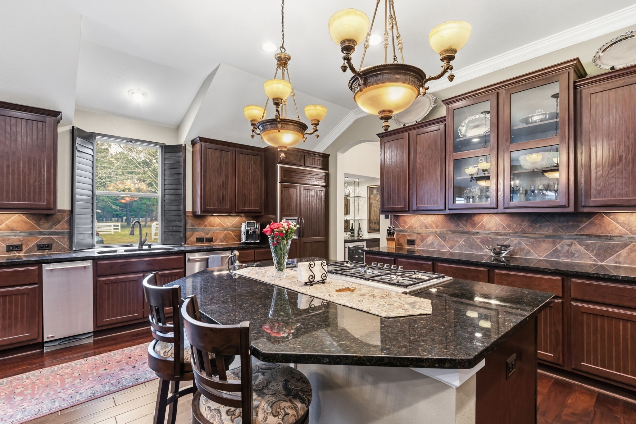 7514 Saddle Blanket Drive Waller, TX 77484 - Photo 18 of 50 Well design kitchen is a chef's dream! Complete with glass front cabinets to display your dishes. A great breakfast bar for those meals on the go! Built-in refrigerator replaced 3/2025.