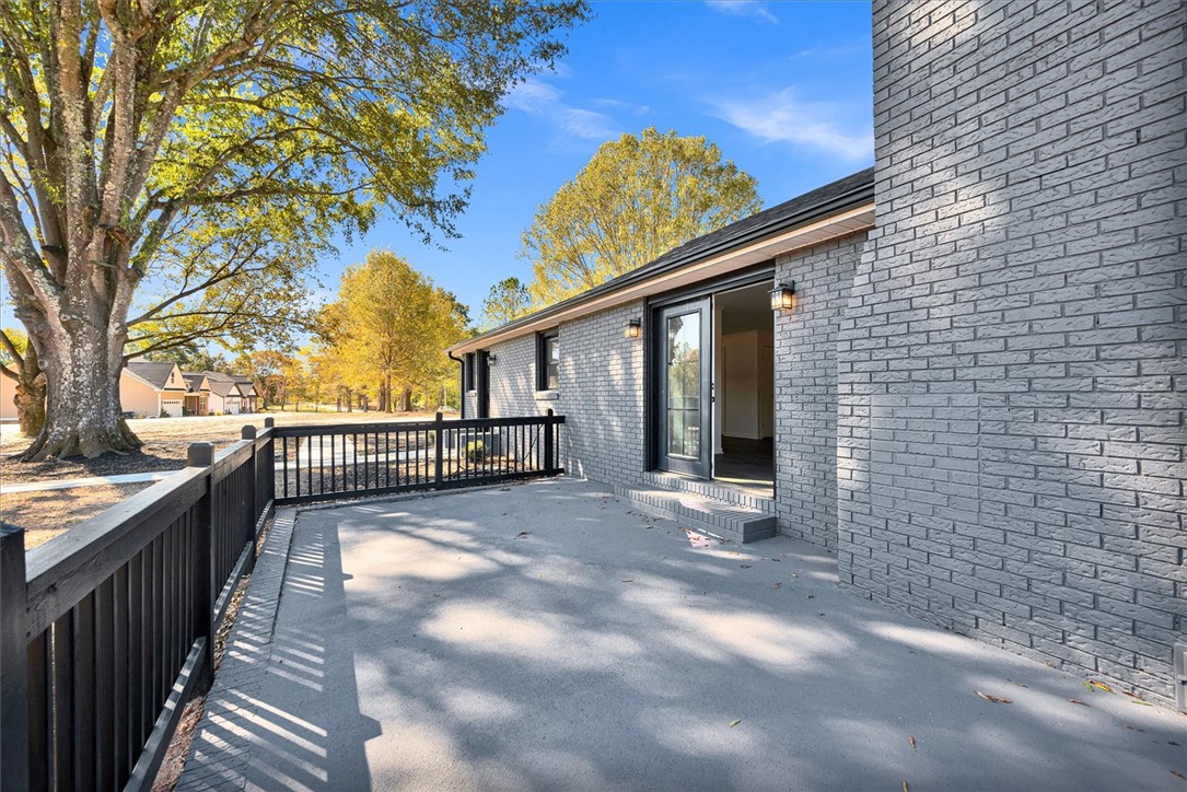 801 Cherokee Road Pelzer, SC 29669 - Photo 32 of 45 This residence features a spacious outdoor patio, ideal for gatherings or tranquil moments amidst natural surroundings.