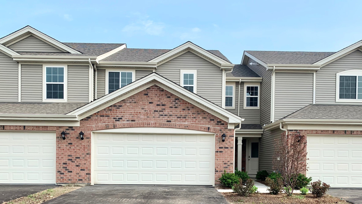 a view of a house with a yard and garage