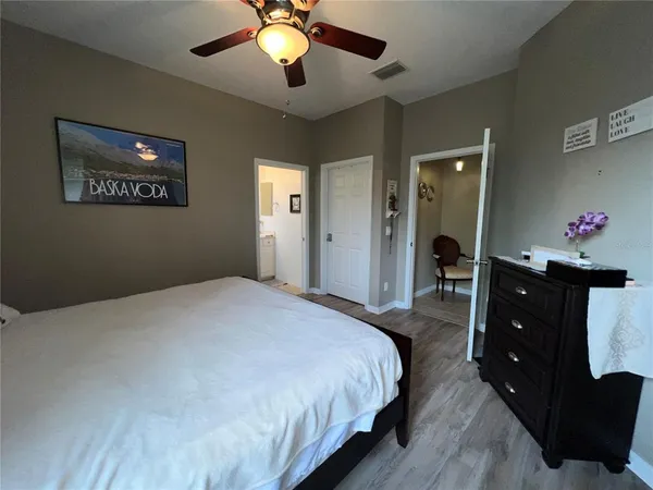 a bedroom with a bed and a night stand