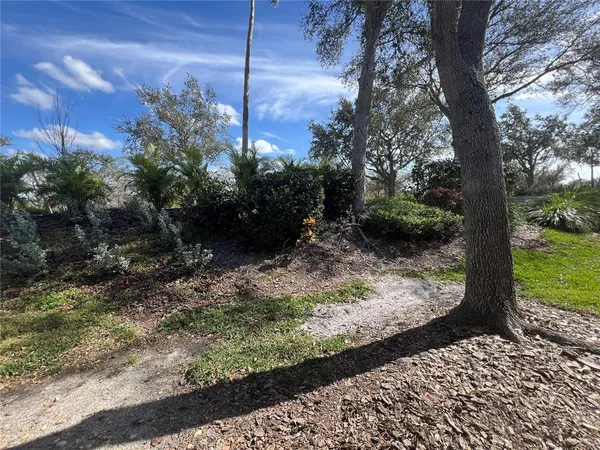 a view of a fence and a yard