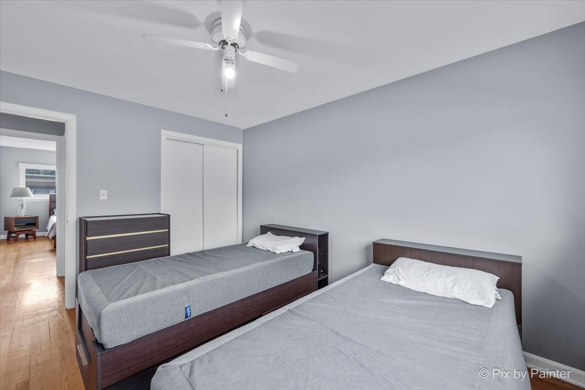 7211 Division Street, Unit C2 River Forest, IL 60305 - Photo 11 of 22 a bedroom with a bed and a chandelier