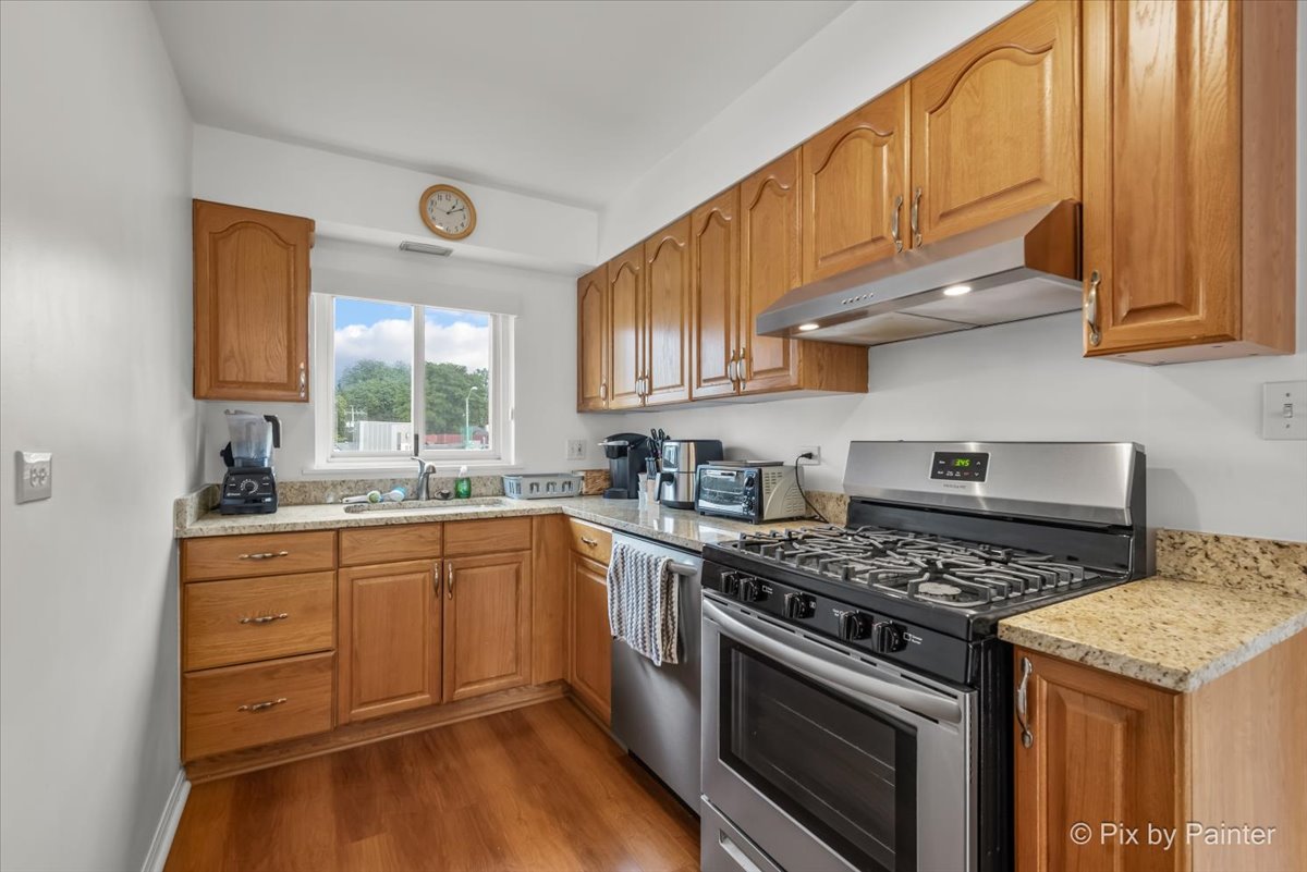 7211 Division Street, Unit C2 River Forest, IL 60305 - Photo 13 of 22 a kitchen with stainless steel appliances granite countertop a stove and a sink