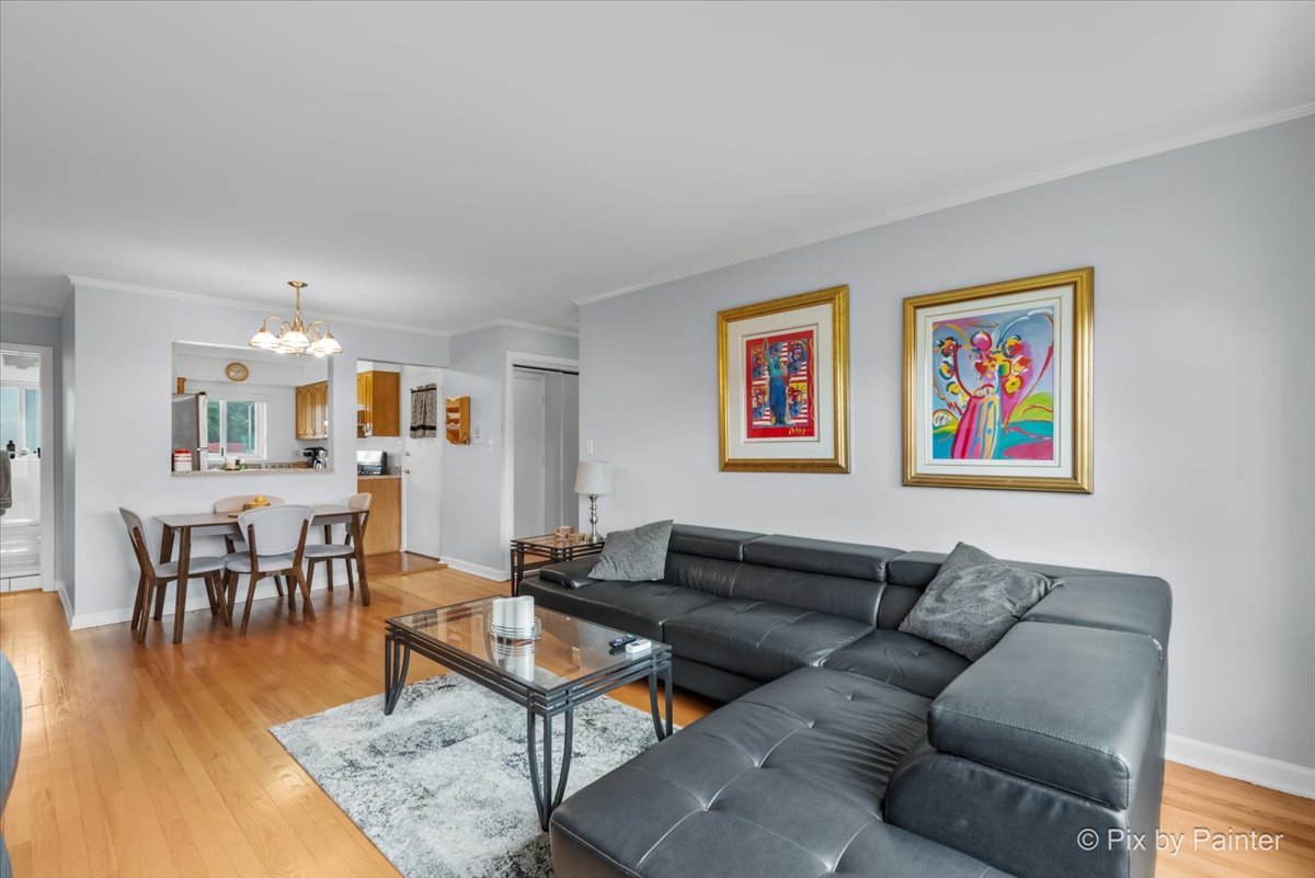 7211 Division Street, Unit C2 River Forest, IL 60305 - Photo 6 of 22 a living room with furniture a wooden floor and a bookshelf