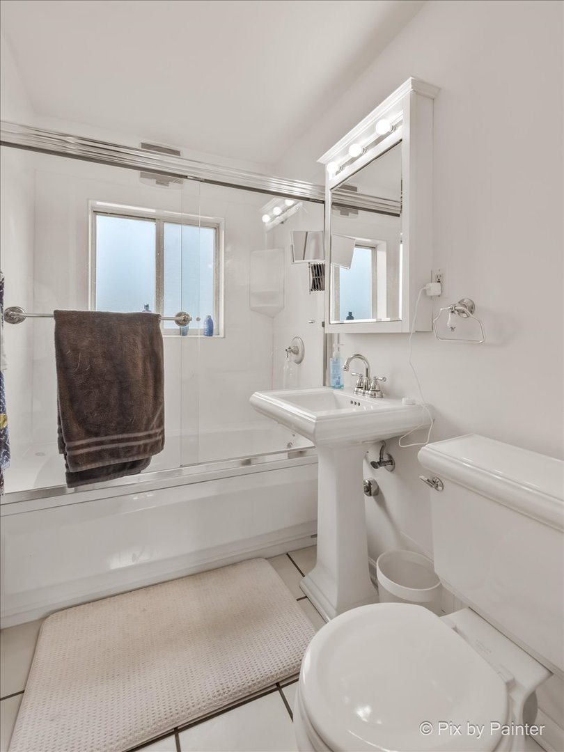 7211 Division Street, Unit C2 River Forest, IL 60305 - Photo 7 of 22 a white toilet sitting next to a bathroom sink