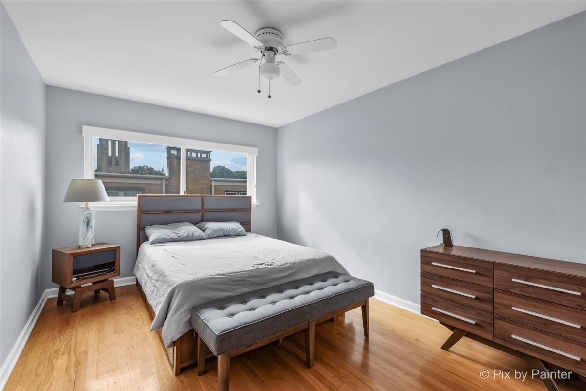 7211 Division Street, Unit C2 River Forest, IL 60305 - Photo 8 of 22 a bedroom with a bed and a chandelier